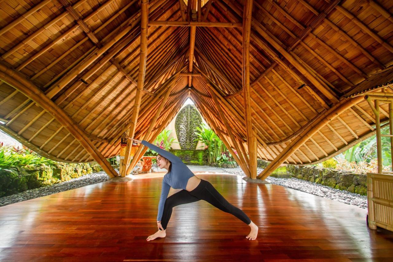 Weda Cita Resort And Spa By Mahaputra Убуд Екстериор снимка A woman practicing yoga at the Four Seasons Resort Maui